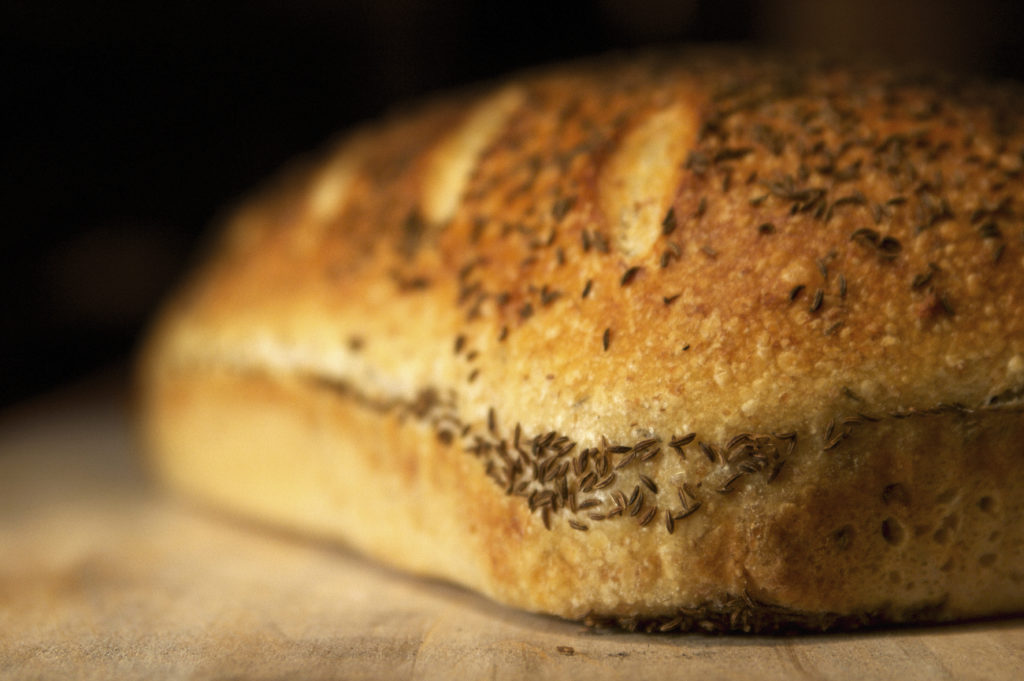 A fresh loaf of bread in a commercial baker’s oven.