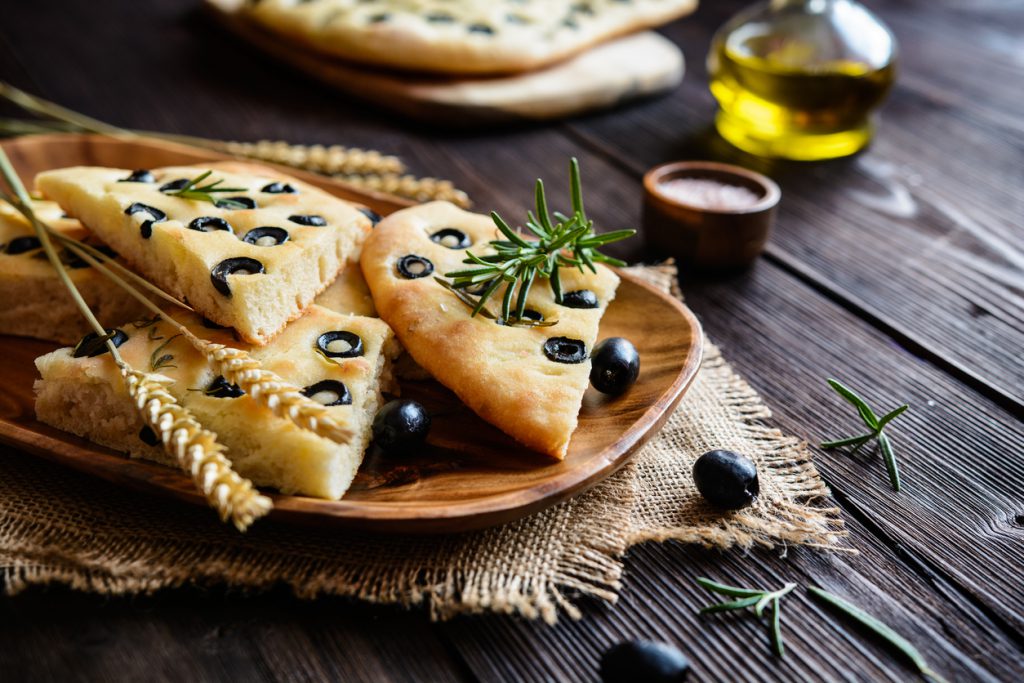 Traditional Italian Focaccia with black olives and rosemary
