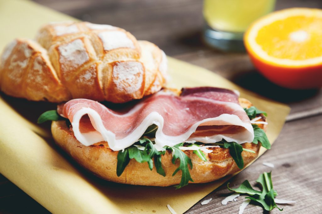 ciabatta bread with prosciutto parmesan and arugula fresh bread and thin sliced ham