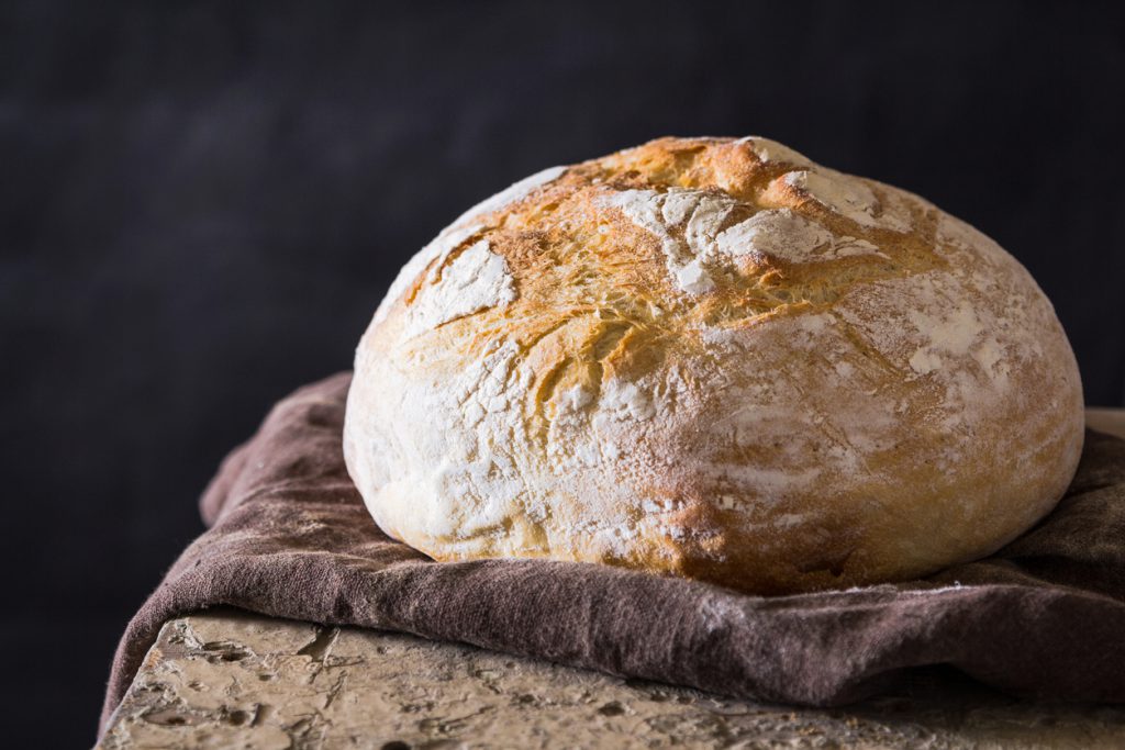 Freshly baked loaf A freshly baked loaf against a dark background