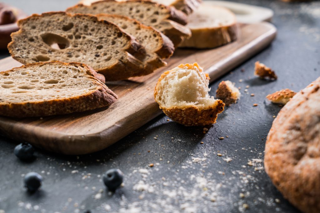Freshly baked bread on wooden table Freshly baked bread on wooden table