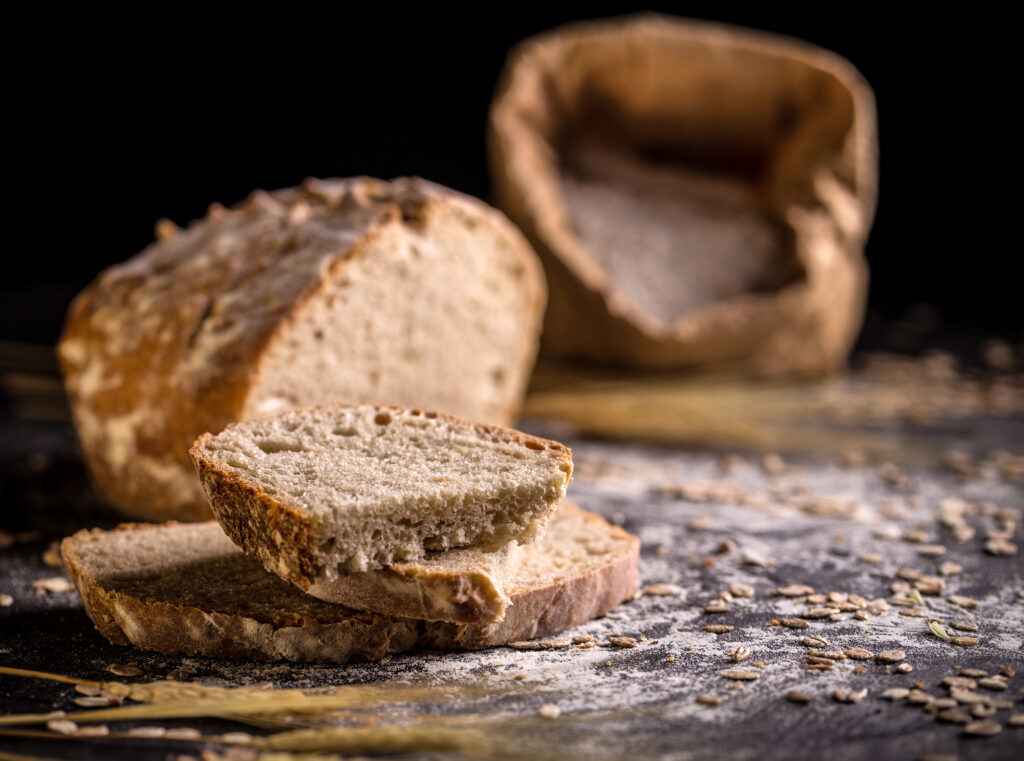 Sourdough bread, sliced on black background