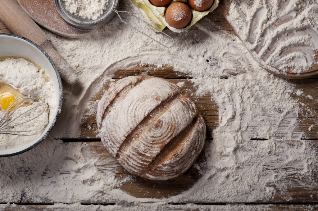 Loaf of bread on a wooden table in a bakery. Top view