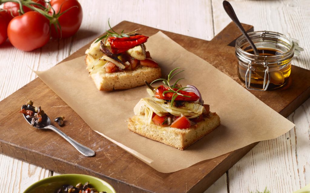 Italian Focaccia tarts with roasted onions, fennel, peppers and served with olive tapenade illustration